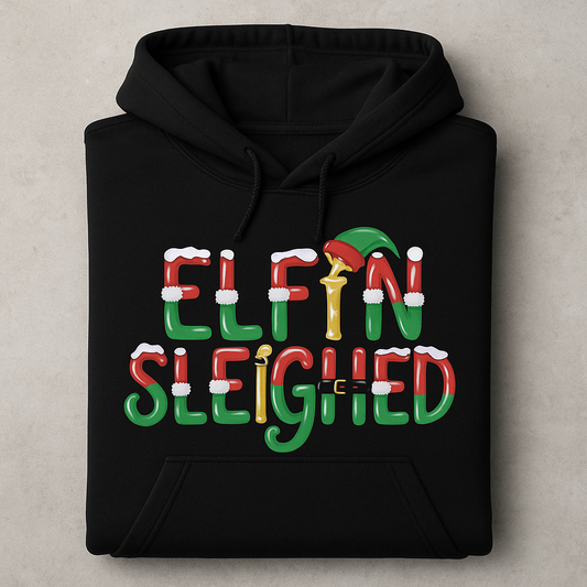 Black hoodie with 'Elfin Sleighed' text and elf graphic on a beige background