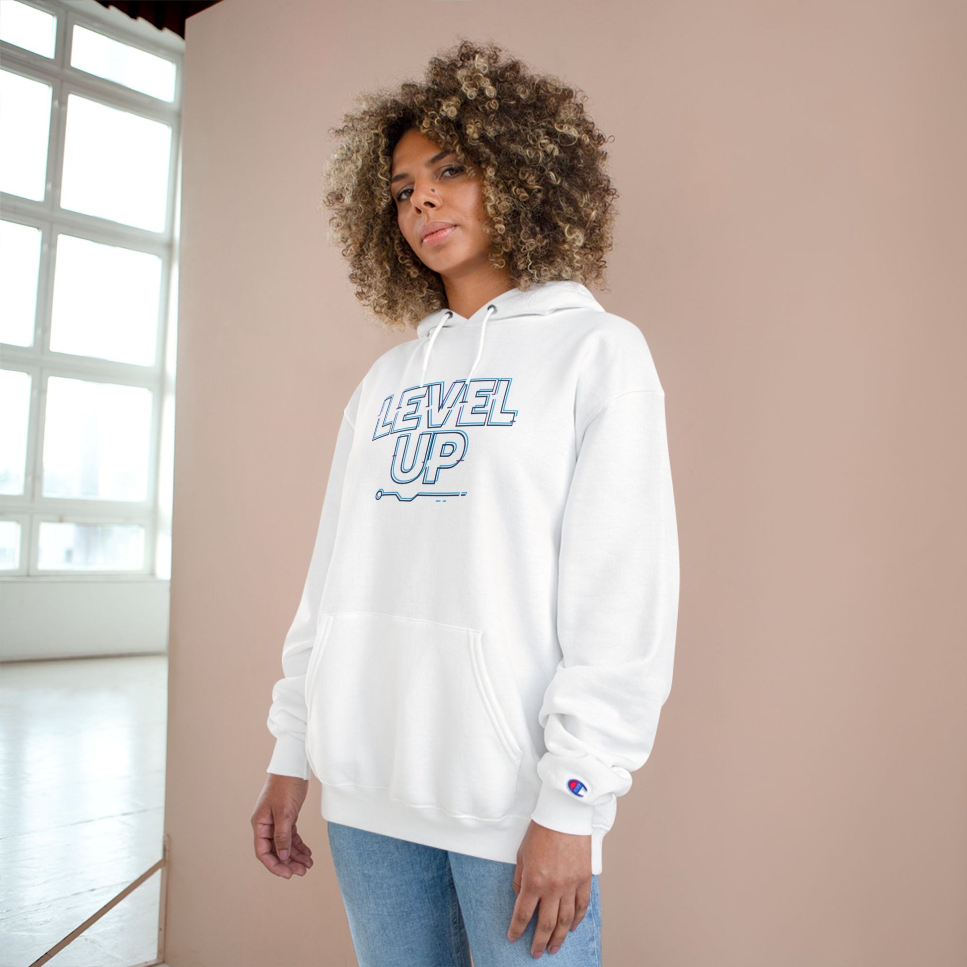 Person wearing a white hoodie with 'Level Up' text in a casual setting