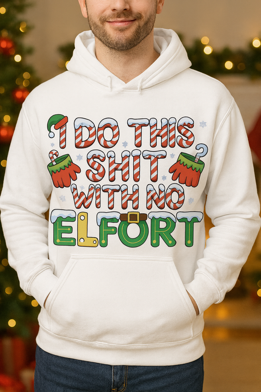 Person wearing a white hoodie with colorful text and graphics in front of a decorated Christmas tree.