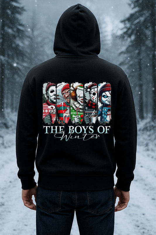 Person wearing a black hoodie with 'The Boys of Winter' design in a snowy forest setting