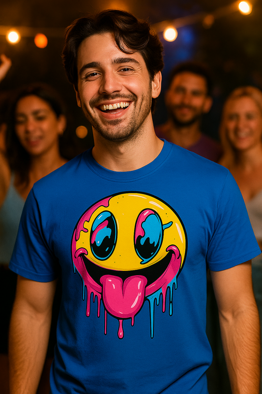 Man wearing a blue t-shirt with a colorful smiley face design, standing in front of a group of people.