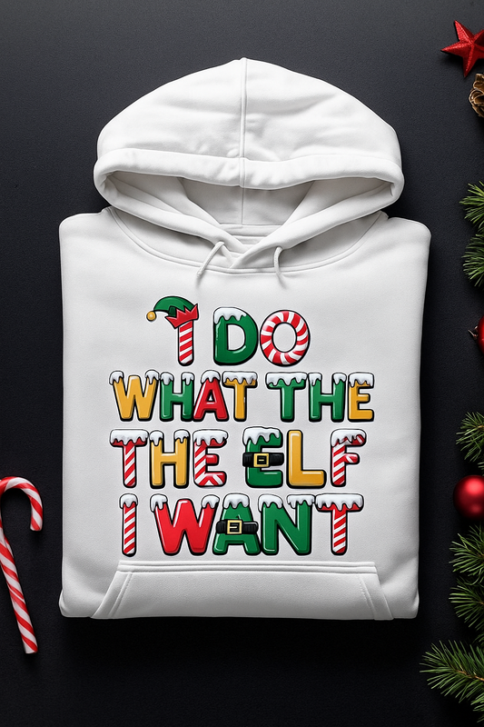 White hoodie with colorful text design on a black background with Christmas decorations.