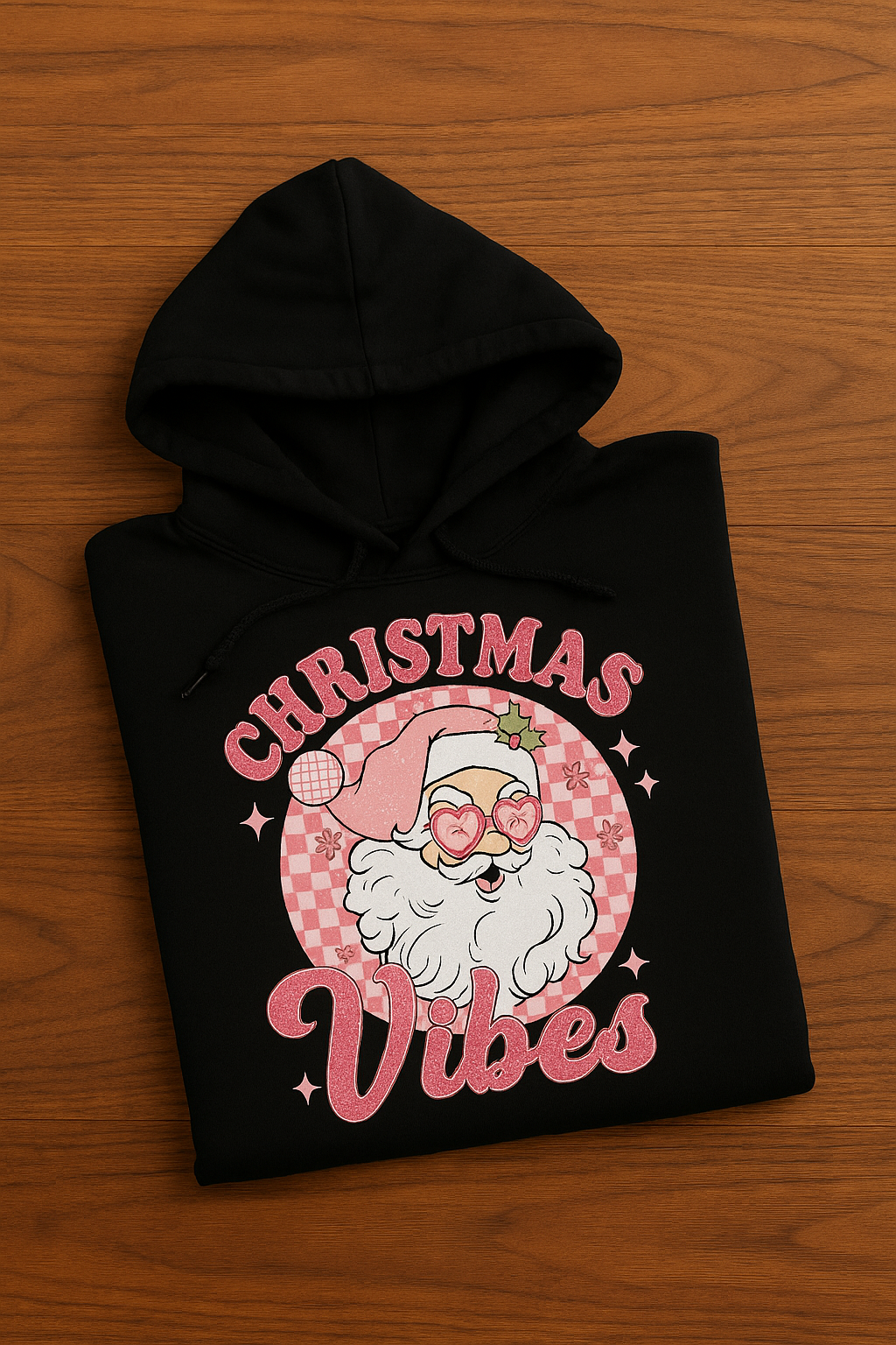 Black hoodie with Christmas-themed design featuring Santa Claus on a wooden surface