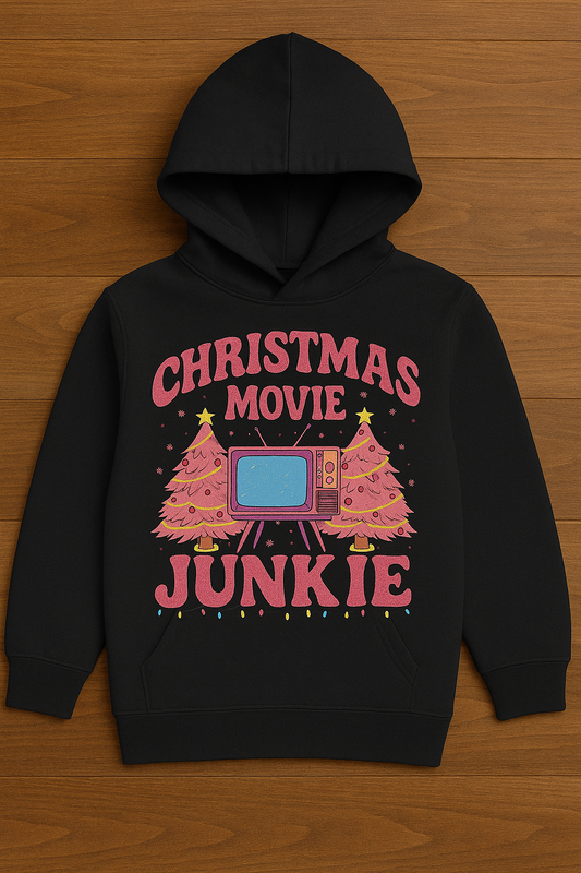 Black hoodie with 'Christmas Movie Junkie' text and graphics on a wooden surface