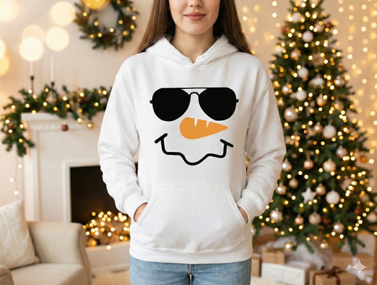 Person wearing a white hoodie with a snowman design in a festive indoor setting