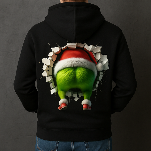 Black hoodie with a festive design of a green character in a Santa hat on a dark background