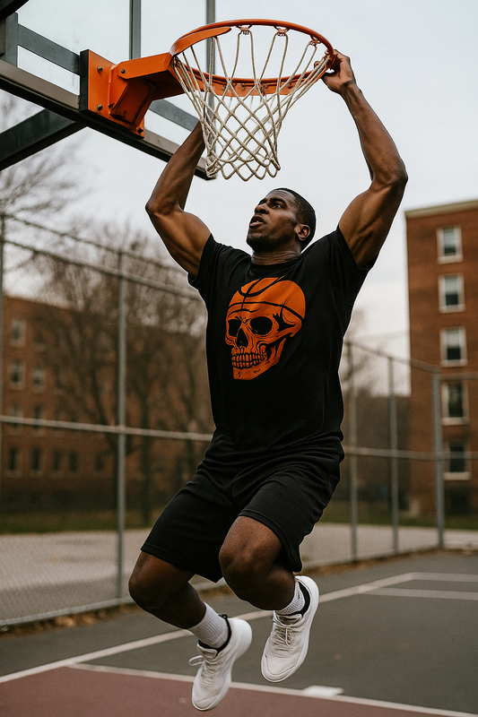Person dunking a basketball in a black t-shirt with a skull design on a basketball court.