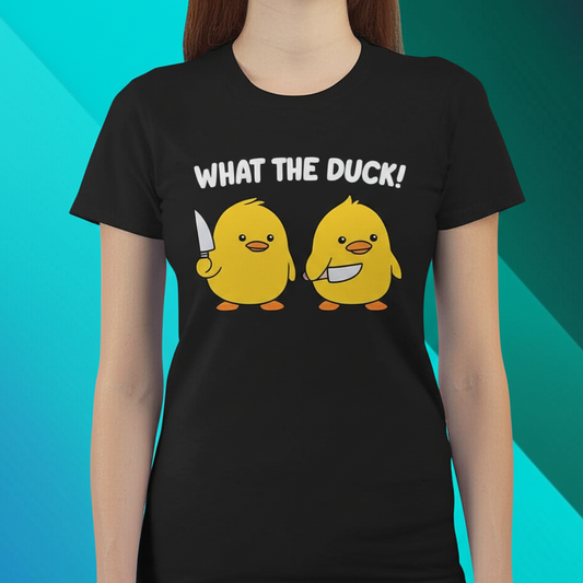 Cartoon t-shirt with two yellow ducks holding knives and the text "What the Duck!" printed on a black shirt, modeled by a woman against an blue green burst background.